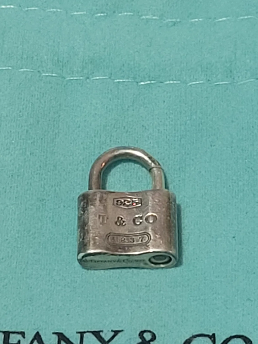 Tiffany & Co. Sterling Silver Padlock Charm on Blue